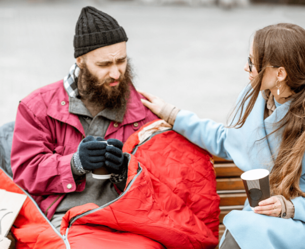 Woman comforting a homeless man